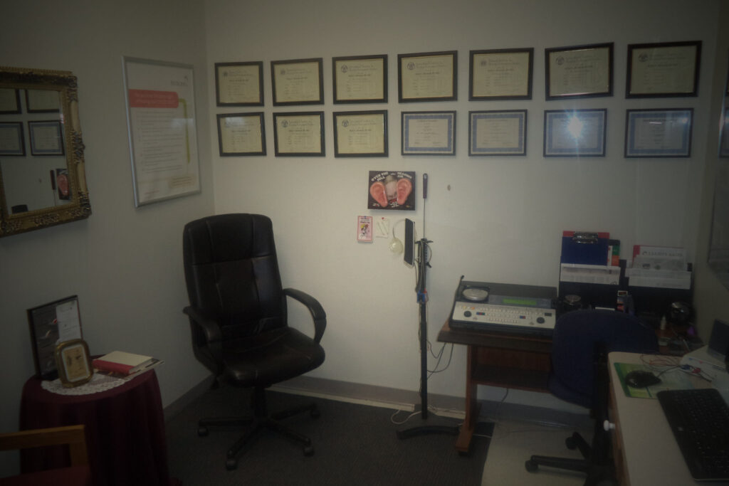 testing room with audiometer and chair in corner
